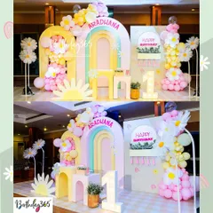 We brought a field of daisies indoors for Aradhana's first birthday. This "daisy paradise" featured a pastel rainbow arch, large daisy props, and a light-up number "1".