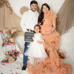 A proud family announcing they are blessed with a baby boy. The big sister-to-be holds the announcement sign, looking so happy to be part of this special moment.