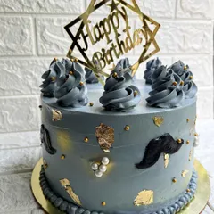 We love creating personalized cakes for any occasion. This stylish grey butterscotch cake is decorated with gold leaf and a mustache theme for a gentleman's birthday.