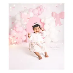 Warning: too much bow-tifulness to handle! This sweet girl's first birthday is celebrated with a lovely pink and white bow-themed setup.