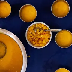 The finished product: creamy mango milkshake ready to be served. The children get to see the process from whole fruit to delicious drink, learning about transformation and enjoying the results.