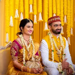 Amidst cascading marigolds and tuberose bunches, the bride and groom glow during their Haldi ceremony. The vibrant yellow floral backdrop creates a traditional and mesmerizing setting for this happy occasion.