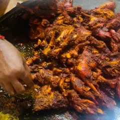 A close-up of our chicken being prepared on a large tawa. This is part of our live cooking service, where guests can see their food being made fresh, adding to the event's atmosphere.