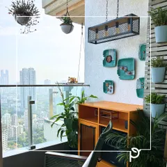 A cozy and stylish balcony corner designed for relaxation. We used hanging planters, wall-mounted pots, and unique furniture to maximize the small space, creating a personal nook with a beautiful city backdrop.
