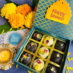 My Diwali gift boxes come in various designs, like this beautiful blue floral one. Inside, you will find a delightful mix of chocolate and white chocolate truffles, some decorated with edible rose petals and pistachios.