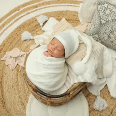 Tucked into a cozy basket with a cute little sleepy hat. This is just perfection. I love creating these warm, snuggly setups for newborn photos.