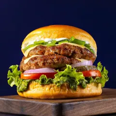 A classic double-patty smash burger, captured for Chili's 'Smasher Burgers' campaign. The focus is on creating a visually appealing, mouth-watering image that performs well for advertising and online menus, highlighting the texture of the patties and freshness of the ingredients.