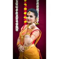 A side profile of a traditional look, highlighting the contouring and the way the makeup complements the intricate gold jewelry. The hairstyle is a neat bun, keeping the focus on the face and accessories.