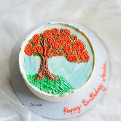 This cake is a tribute to the beautiful Gulmohar tree. The design is hand-piped with colored buttercream to create a miniature painting you can eat.
