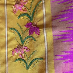 Another detail of the custom Kamal Kadai work, showing the delicate floral vine. I carefully select thread colors to complement the saree's base, ensuring the embroidery enhances the beauty of the original textile.