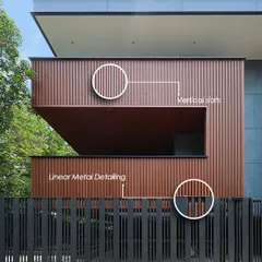 This facade creates a visual rhythm through an interplay of vertical slats and linear metal detailing on the fence and building. The details add texture and define proportion, creating a distinct architectural identity that is modern, minimal, and enduring.