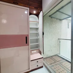 This shows a hidden feature of the sliding wardrobe: a slim, pull-out cabinet with shelves, perfect for storing accessories, cosmetics, or shoes.