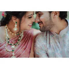 A close-up, romantic shot of a couple, highlighting the bride's beautiful jewelry and their happy smiles.
