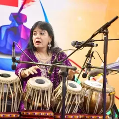 Explaining a rhythmic concept during my performance for corporate leaders and dignitaries. My goal is to make Indian classical music accessible and demonstrate its practical applications for focus, creativity, and stress management in a professional environment.