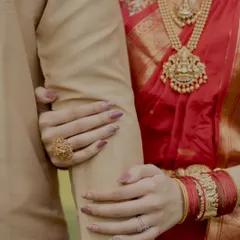It's all in the details. This close up shot focuses on the bride's hands holding the groom's arm, a simple yet powerful symbol of their bond.