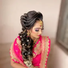 A stunning bridal hairstyle perfect for a wedding or reception. This intricate braid is woven with highlights and decorated with delicate pearls for an elegant and unforgettable look.