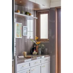 This utility and storage counter shows our focus on practical design. The combination of open shelves and closed cabinets, along with decorative elements, makes the space both useful and beautiful.