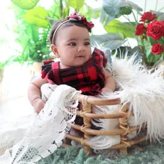 This three-month-old baby girl looks so curious and alert sitting in a rustic basket. Sitter and milestone sessions are perfect for capturing their budding awareness of the world around them.