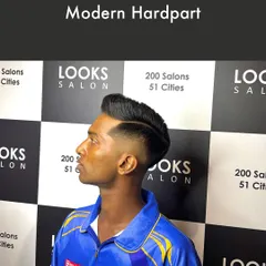 Inspired by the sharp looks on the cricket field, this Modern Hardpart haircut features a clean, defined part and a skin fade. It's a bold, athletic style that's perfect for making a statement.