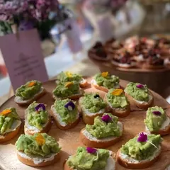 A simple yet elegant appetizer perfect for any celebration. These are my avocado toast canapés, featuring creamy mashed avocado on toasted baguette slices, garnished with delicate edible flowers. They are always a crowd-pleaser.