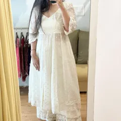 A mirror selfie showing our white cotton Angrakha dress. This piece features delicate all-over threadwork detailing and is paired with matching palazzos, offering a look that is both traditional and contemporary.