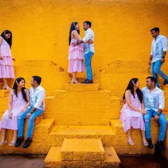 A creative and playful pre-wedding photo using a unique location with vibrant yellow steps. This composite shot captures different interactions, telling a small story within a single frame.