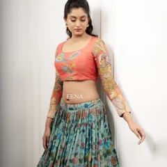 Discover the beauty of traditional craftsmanship with this stunning Pen Kalamkari lehenga. The piece is meticulously hand-painted by my artisans, with a story unfolding on the blouse sleeves and a beautiful floral pattern on the skirt and dupatta.
