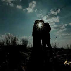 A dramatic pre-wedding silhouette against a brilliant sunburst. I use natural light to create powerful and artistic images that feel timeless.