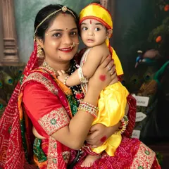 A mother and her baby, dressed as Yashoda and Krishna, share a beautiful moment during our Janmashtami special photoshoot.