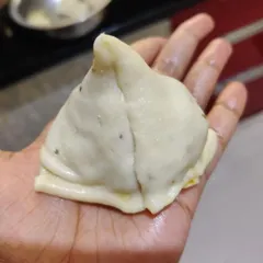 Each samosa is shaped by hand to ensure a perfect, crisp pocket for the delicious filling.