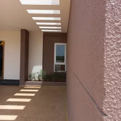 A different angle of the walkway, showing how the light patterns move and change, and how the textured exterior wall catches the light. These small details bring a building to life throughout the day.
