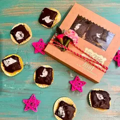 Our 'Nutty Rock' chocolates, a Rakhi special, beautifully packed in a gift box. These soft-centered, nut-filled chocolates are a delightful way to celebrate the bond with your sibling.