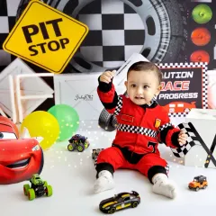 Ready, set, go! For the little one who's always on the move, my race car theme is a total winner. The checkered flags, pit stop signs, and cool cars make for such an energetic and fun first birthday photoshoot.