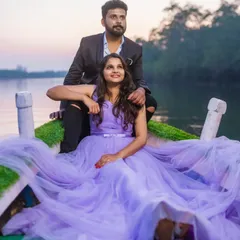 A dreamy pre-wedding shoot on a boat. The soft lavender tulle of this gown spreads out around the couple, creating a romantic and serene atmosphere on the water at sunset.