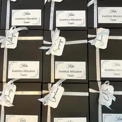 Attention to detail is key, even in large orders. These gift boxes for the Saks Inventory Allocation Team feature personalized name tags, making each team member feel individually recognized.