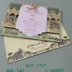 A stunning laser-cut invitation with a detailed palace facade and elephants. The main invite is a shaped tag that hangs in the center, creating a beautiful and interactive design.