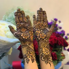A beautiful example of floral patterns on the palms. The design is dense and rich, with different types of flowers and shading techniques used to create depth and texture.