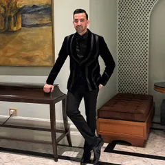 For Ali's celebration, I crafted this black velvet tuxedo. The structured satin lapels create a sharp, powerful silhouette, perfect for a black-tie event or reception.