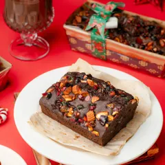The quintessential Christmas dessert, a rich plum cake. We styled this shot with a cozy, festive theme to evoke the warmth and joy of the season.