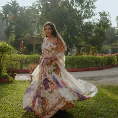 A beautiful shot of the bride twirling in her floral gown. The motion captures the flow of her dress and her joyful spirit.