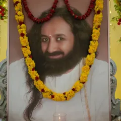 A portrait of me adorned with a garland during Guru Purnima celebrations. This day is a special occasion to honor the lineage of spiritual masters and express gratitude for the wisdom they have preserved.