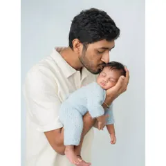 A father's loving kiss for his sleeping newborn. These are the simple, powerful moments of connection that I aim to preserve for your family.