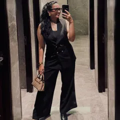 A chic and modern formal look with a black waistcoat and wide-leg pants. This outfit is ideal for hosting a stylish corporate party or an art gallery opening.