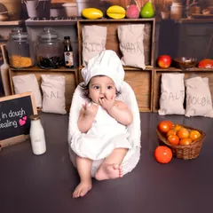 Another angle from the 'Little Chef' photoshoot, this time with a charming sign that reads 'Rolling in dough and stealing hearts'. I love adding these little details to make each session unique.