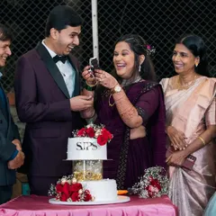 A moment of surprise and joy during the cake cutting ceremony, surrounded by close family. These are the memories you'll cherish.