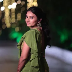 A lovely portrait of the bride's sister. The makeup highlights her features beautifully against the evening lights, and the hairstyle keeps the look chic and manageable.