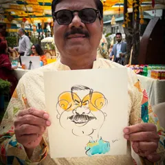 A happy guest at a Mussoorie wedding, holding his fun portrait. My live art adds a unique touch of entertainment to destination weddings.