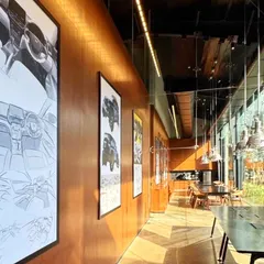 The collaborative spaces in the Automobile Design Studio are designed to inspire. A long gallery wall with warm wood paneling displays automotive sketches and renders, creating a space for informal reviews and discussions that is steeped in the language of design.