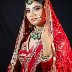 A stunning close-up of a traditional red bridal look. Notice the perfectly blended eyeshadow, sharp winged liner, and the intricate placement of the maang tikka and nath. I teach these detailed techniques for a picture-perfect result.