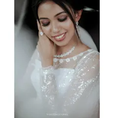A beautiful, soft-focused portrait of a Christian bride in her car, capturing a quiet moment of reflection before the ceremony.